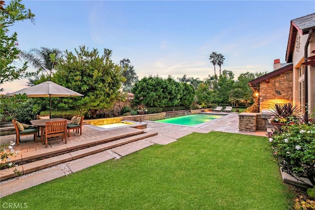 view of swimming pool featuring a yard and a patio