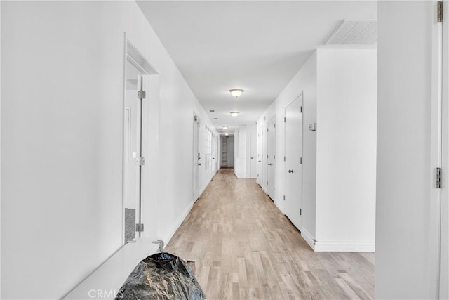 corridor with light hardwood / wood-style flooring