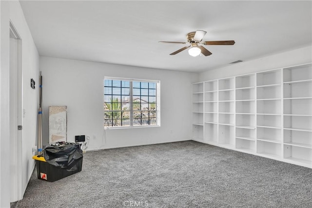 carpeted empty room featuring ceiling fan