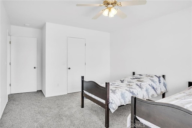 bedroom with ceiling fan and light carpet