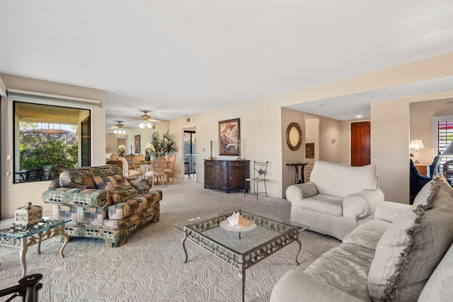 carpeted living room featuring ceiling fan