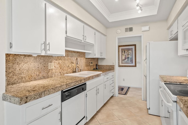 kitchen with white appliances, crown molding, a raised ceiling, sink, and white cabinetry