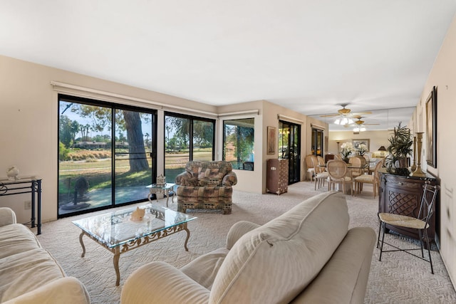 living room featuring ceiling fan and light colored carpet