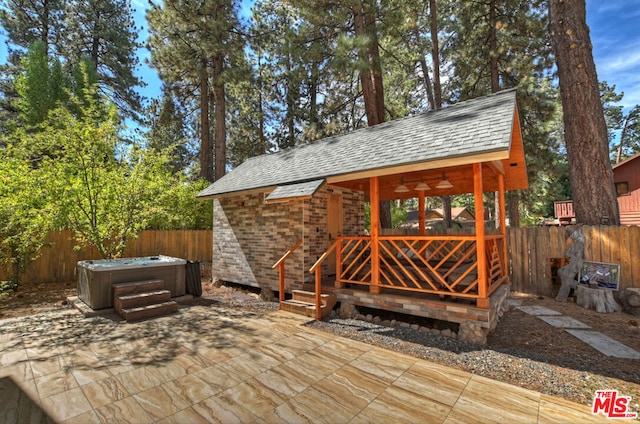 wooden deck featuring a patio, a hot tub, and ceiling fan