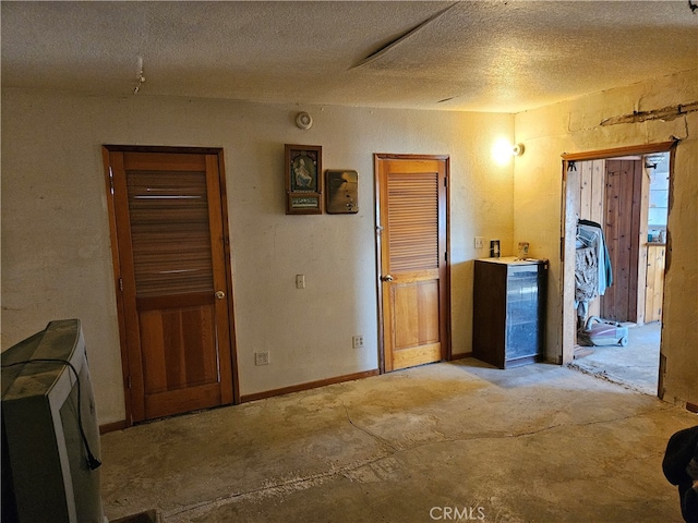 unfurnished room with a textured ceiling