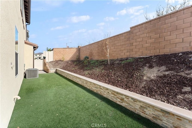 view of yard featuring a fenced backyard and cooling unit