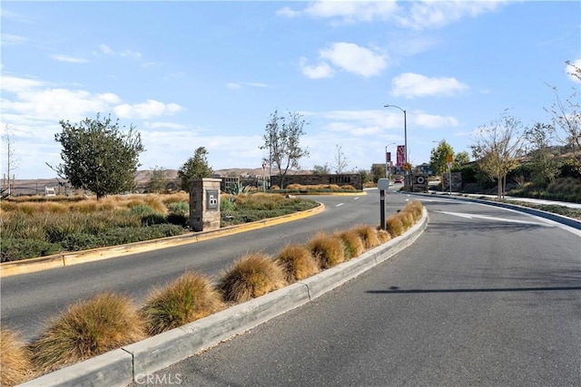 view of street featuring curbs and street lights