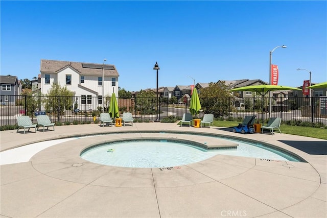 view of swimming pool with a patio area and an in ground hot tub