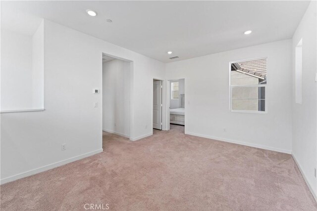 unfurnished room with recessed lighting, baseboards, visible vents, and light colored carpet