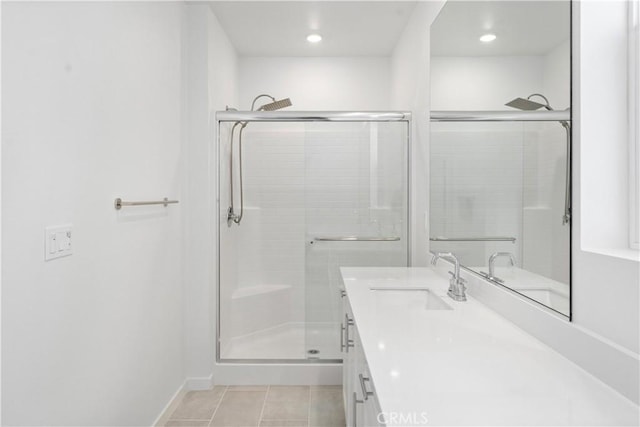 bathroom with vanity, a shower with door, and tile patterned flooring