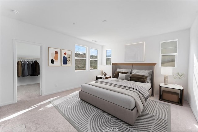 carpeted bedroom featuring a spacious closet and a closet