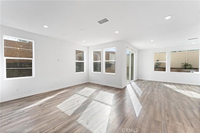 unfurnished living room featuring visible vents, wood finished floors, and recessed lighting