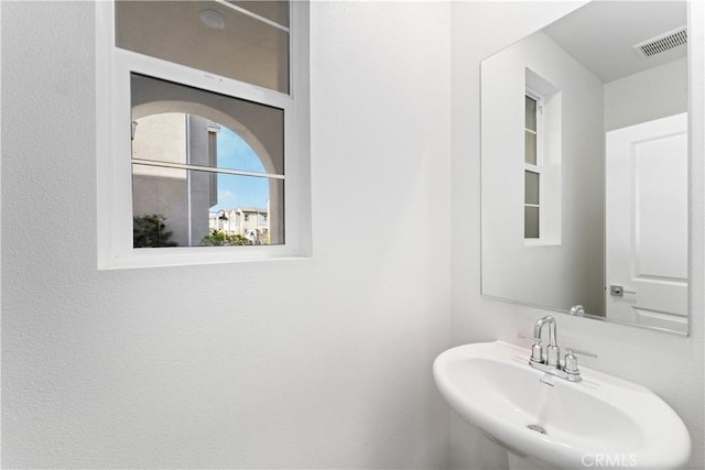 bathroom with visible vents and a sink