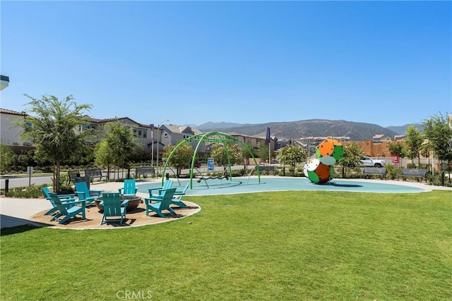 surrounding community with a mountain view and a yard