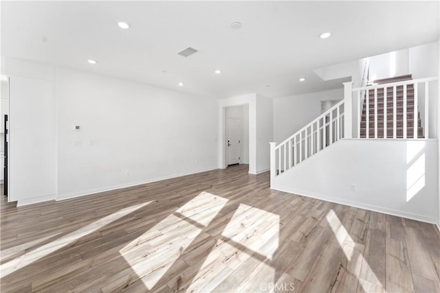 unfurnished living room with hardwood / wood-style floors