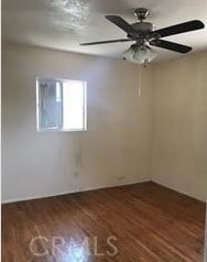 unfurnished room featuring ceiling fan and dark wood-type flooring