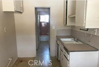 kitchen featuring sink and white cabinetry