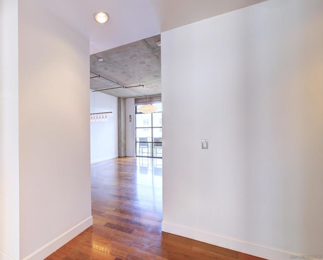 corridor featuring floor to ceiling windows and hardwood / wood-style flooring