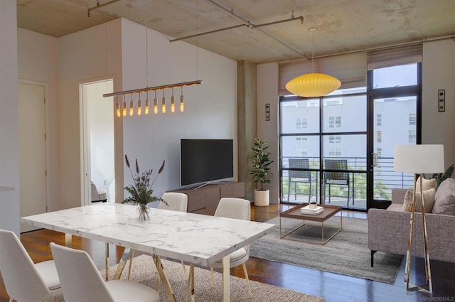 dining space with dark wood-type flooring and floor to ceiling windows