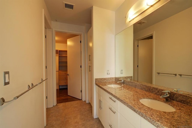 bathroom with tile patterned flooring and vanity