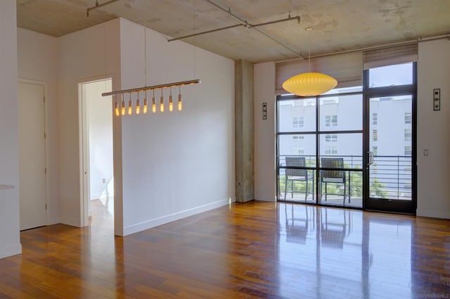 spare room with hardwood / wood-style flooring and expansive windows