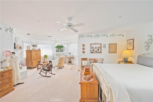 bedroom with ceiling fan, light colored carpet, and a textured ceiling