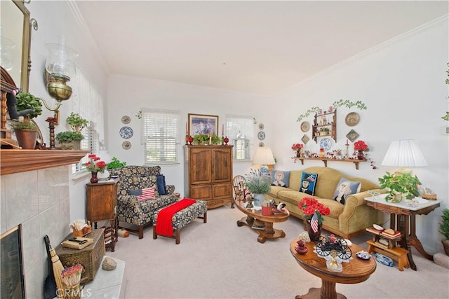 living room with crown molding, light carpet, and a tile fireplace