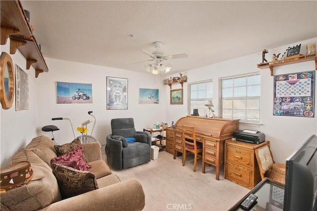 home office with ceiling fan, light colored carpet, and a textured ceiling