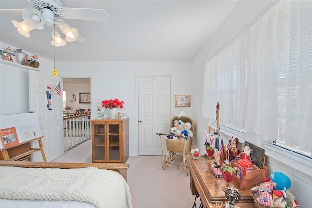 bedroom with ceiling fan and light colored carpet