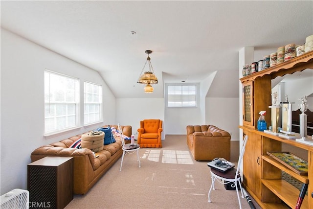 living room featuring lofted ceiling and light carpet