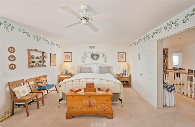 bedroom with ceiling fan and light carpet