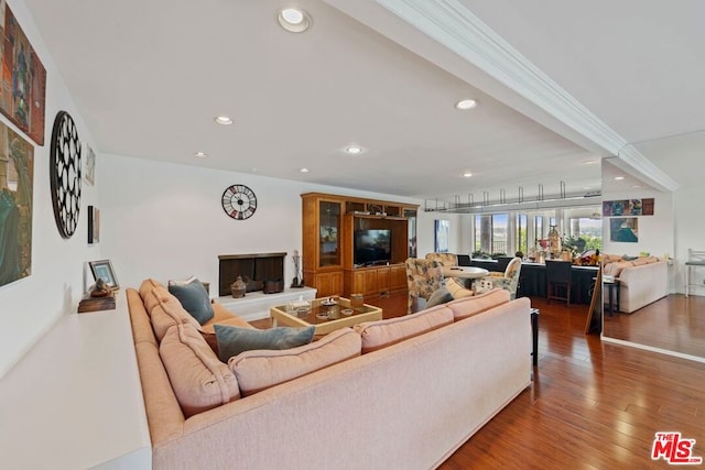 living room with ornamental molding and wood-type flooring