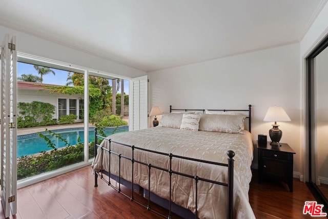 bedroom featuring crown molding and hardwood / wood-style flooring