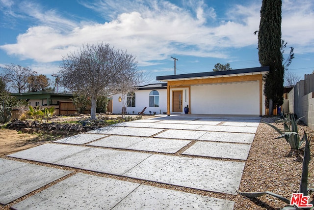 view of front facade with a garage and a patio