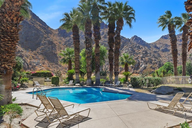 view of swimming pool featuring a mountain view and a patio