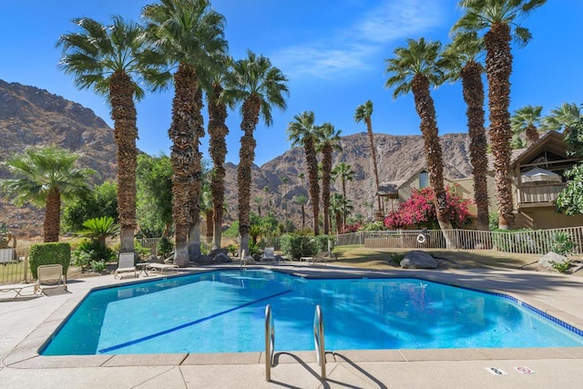 view of pool featuring a mountain view and a patio