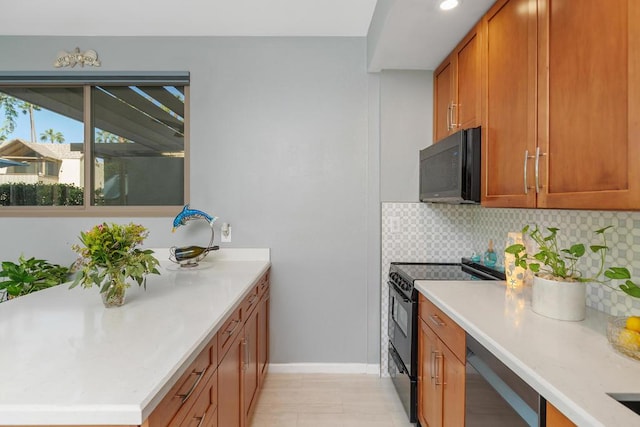 kitchen featuring black appliances and tasteful backsplash