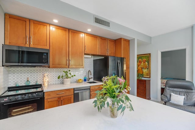 kitchen with decorative backsplash, sink, and stainless steel appliances