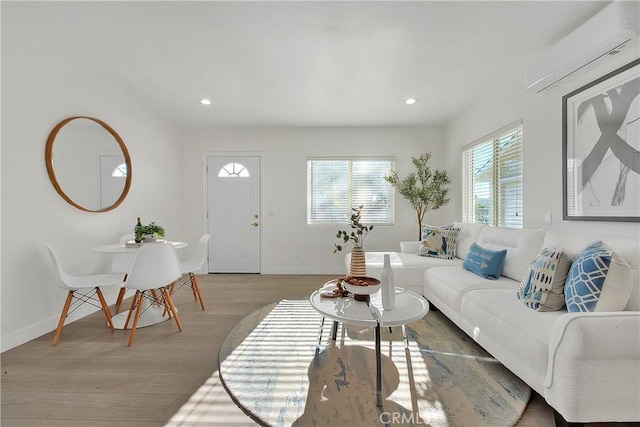 living room with hardwood / wood-style flooring and a wall mounted AC