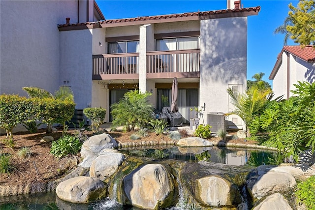 back of property featuring a balcony