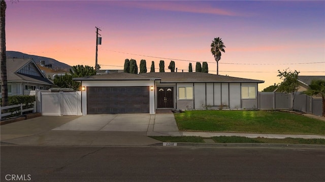 view of front facade with a garage and a yard