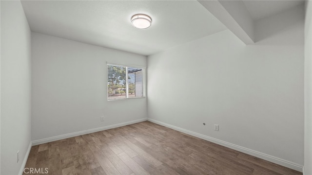 spare room with hardwood / wood-style flooring