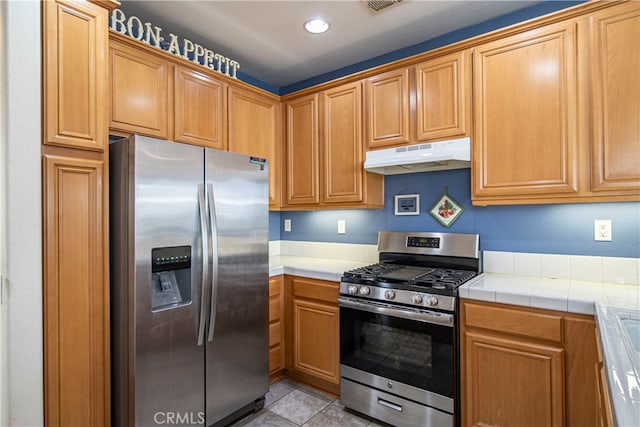 kitchen featuring stainless steel appliances and tile counters