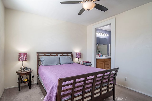 bedroom with ensuite bathroom, ceiling fan, and light carpet