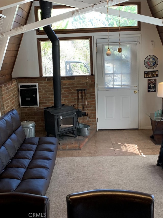 living room with vaulted ceiling, tile patterned floors, and a wealth of natural light