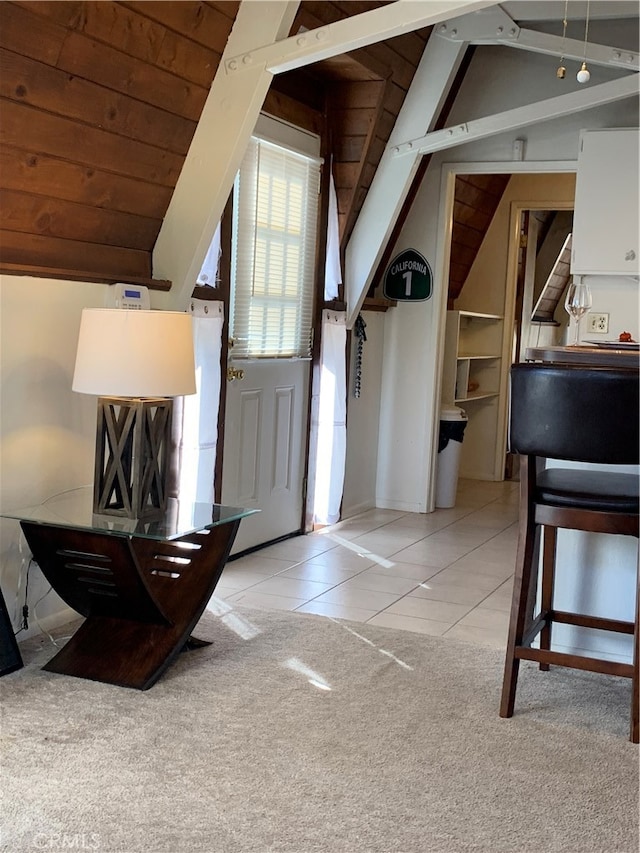 foyer featuring light tile patterned flooring, lofted ceiling, and wood ceiling