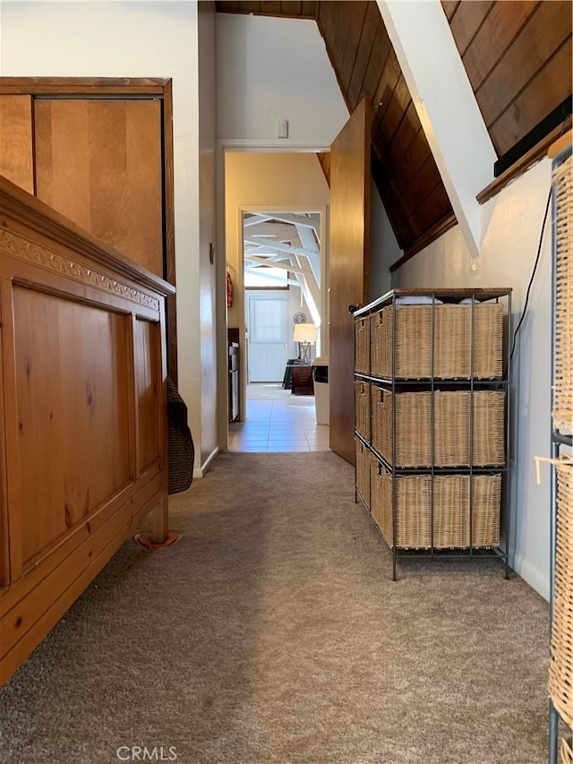 hall featuring wood ceiling, lofted ceiling with beams, and light carpet