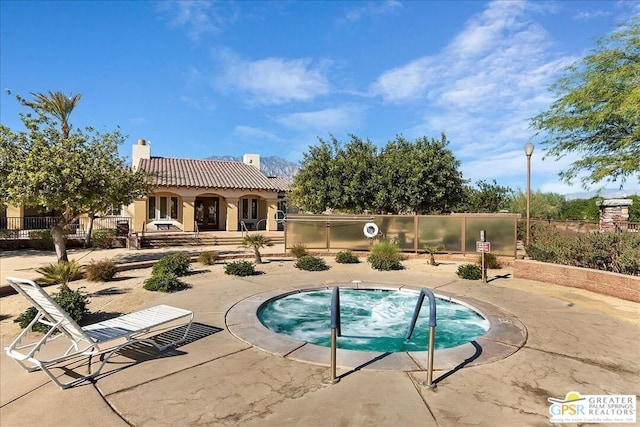 view of pool featuring a patio area and a hot tub