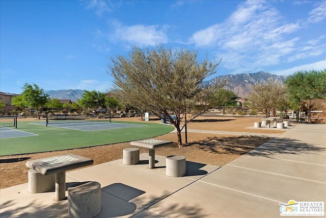 surrounding community with tennis court and a mountain view