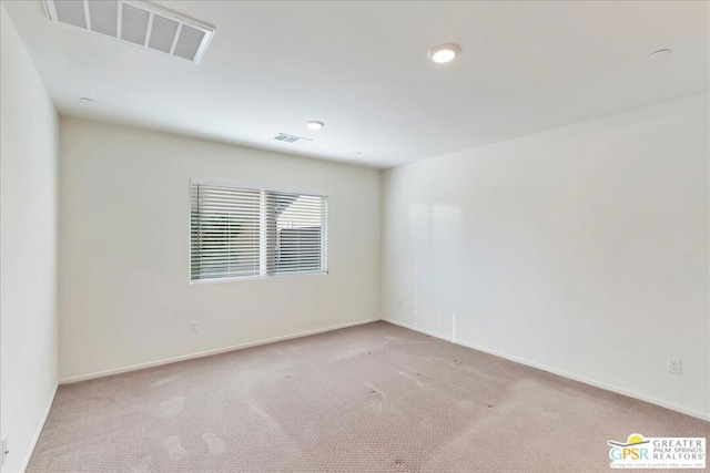 unfurnished room with light carpet